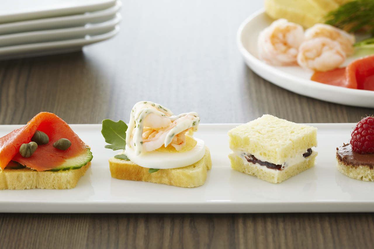 Beautiful and colourful tea sandwiches arranged on a platter