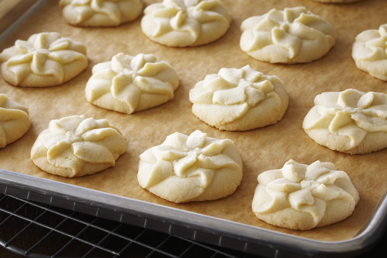 Anna Olson's piped vanilla bean shortbread cookies on a parchment-lined tray