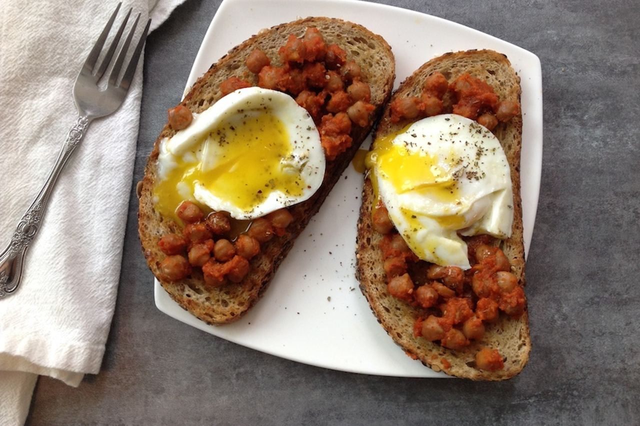 An overhead shot of smoky cooked chickpeas and egg on toast
