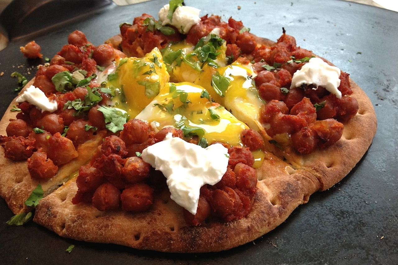 A pizza with smoky chickpeas and egg