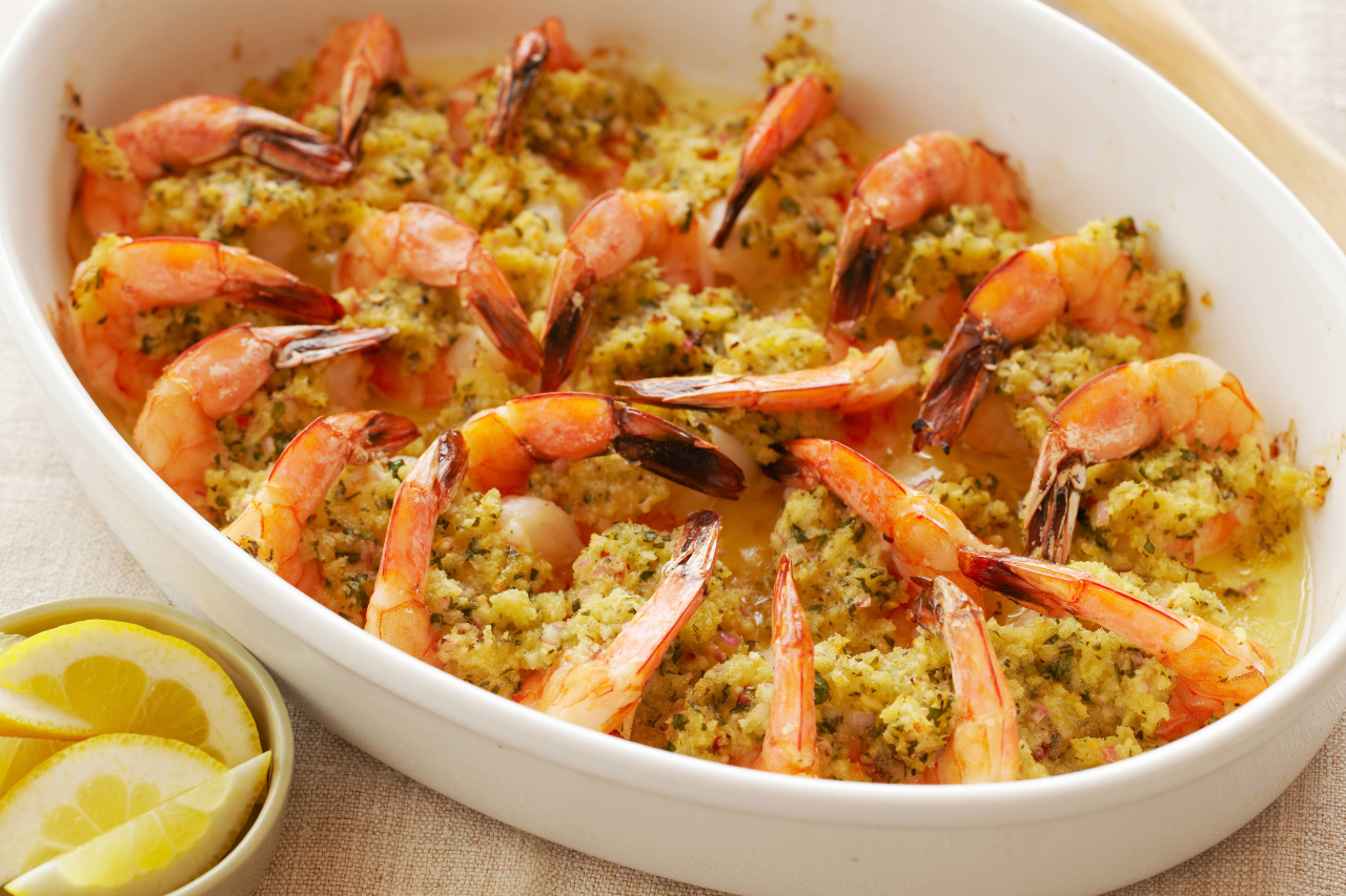 A casserole dish with a vibrant-coloured baked shrimp scampi