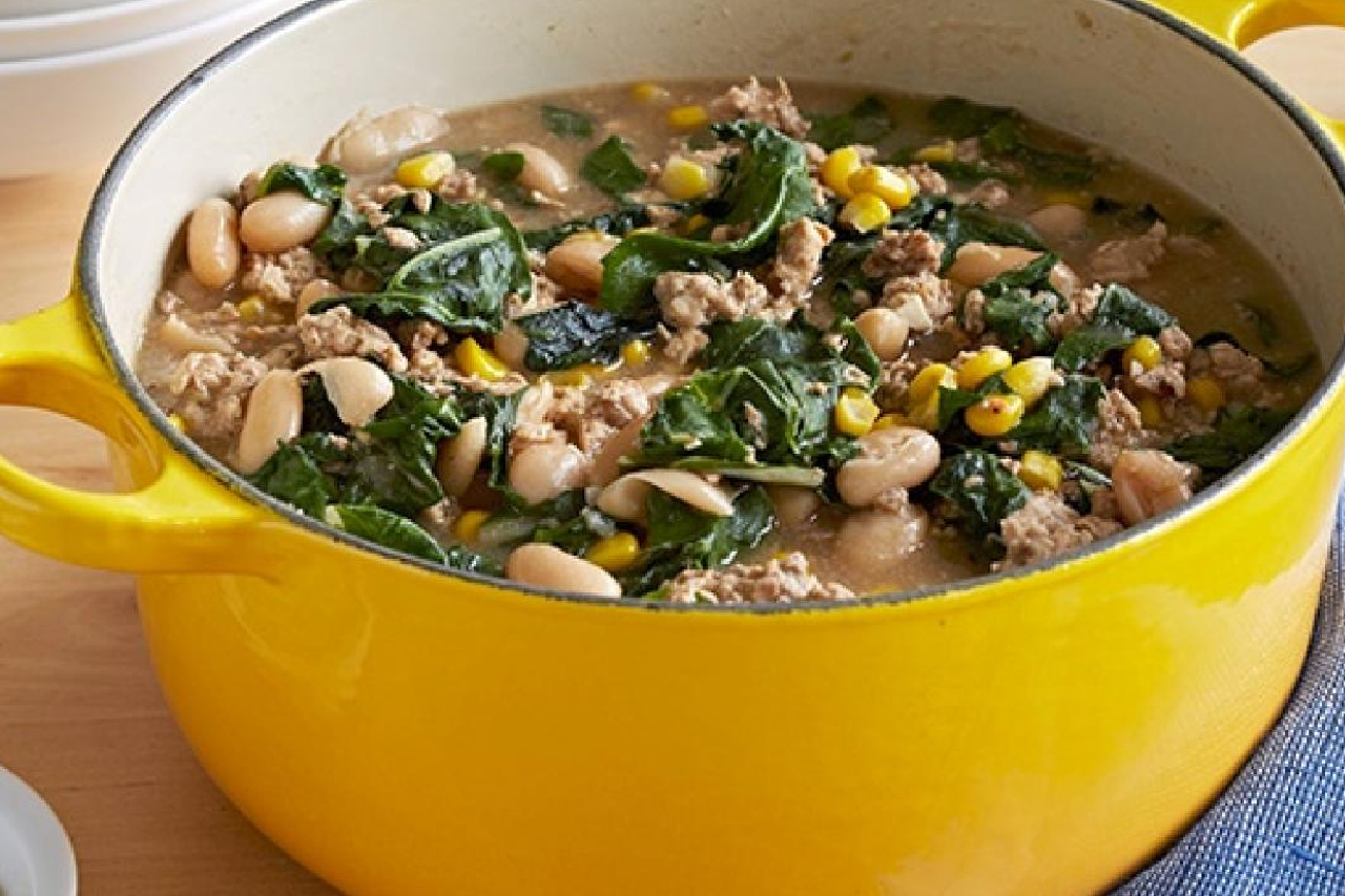 A yellow cast iron pot with a white bean and chicken chili