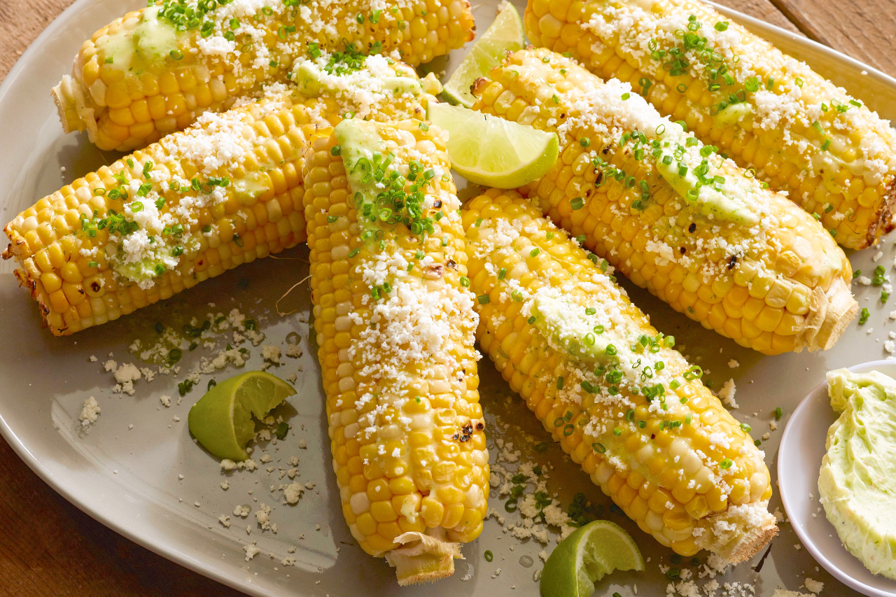 Grilled corn on the cobs with cotija cheese and fresh herbs
