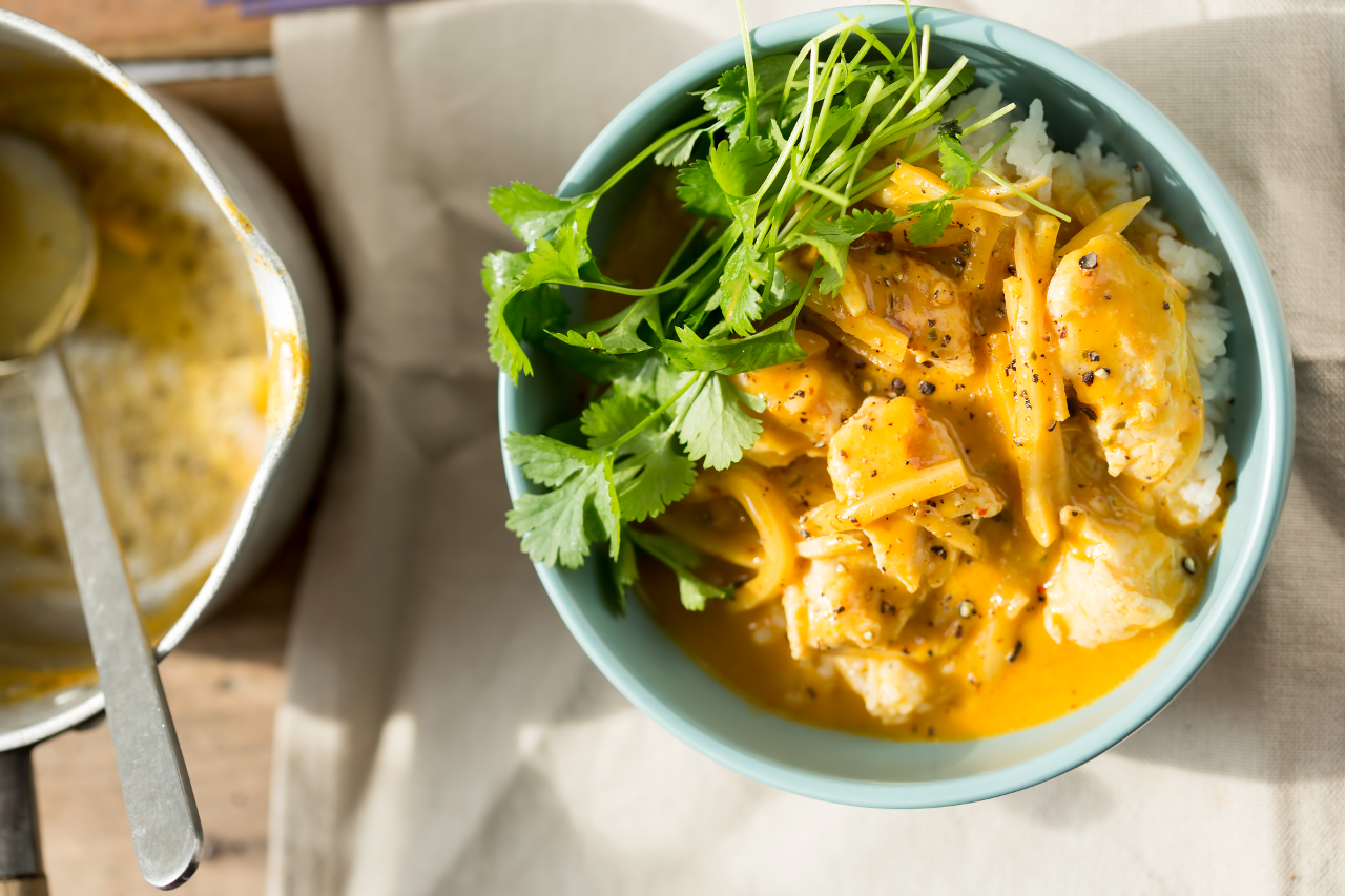 Chicken curry with mango and coriander and rice - stock photo