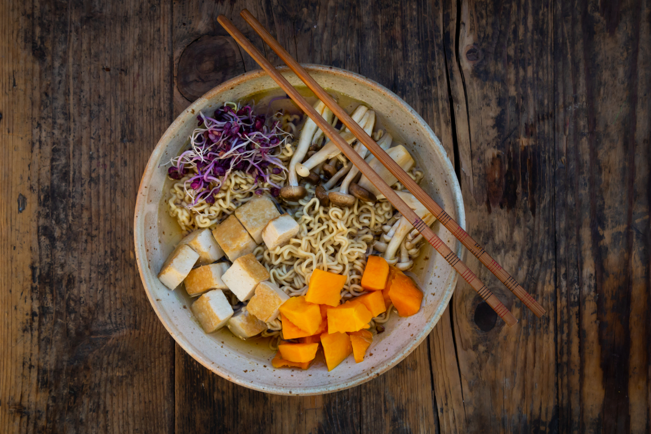 Miso Ramen soup with noodles, red radish sprouts, pumpkin, fried tofu, shimeji and king trumpet mushroom - stock photo