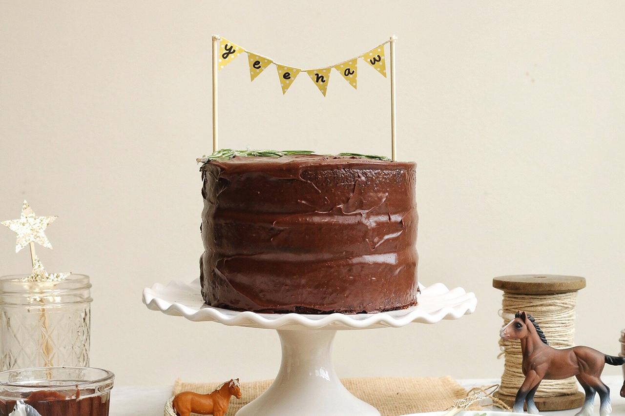 festive cowboy chocolate cake on a cake round with decorations
