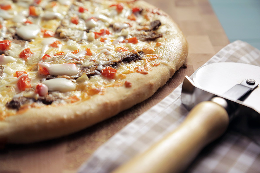 An overhead shot of a cheesy Canadian donair pizza