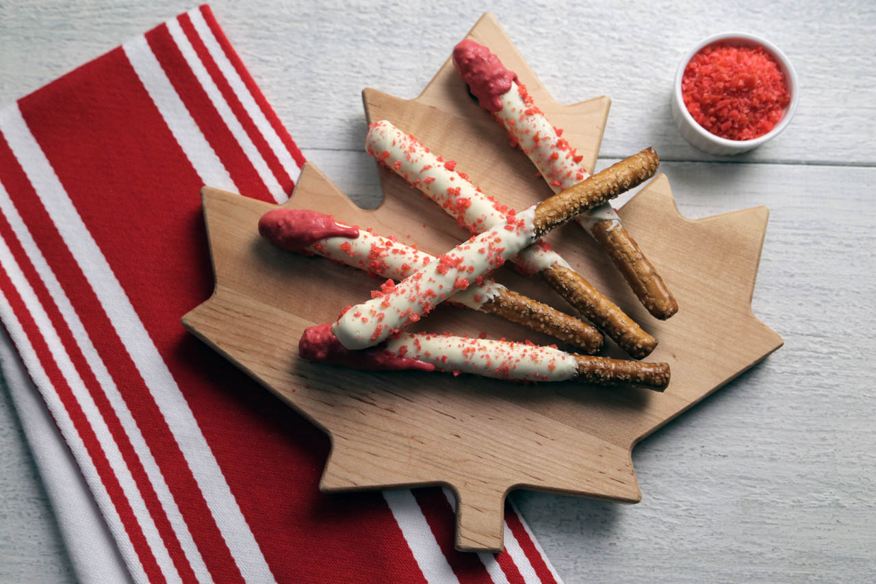 Canada Day pretzel sparklers on a maple leaf cutting board
