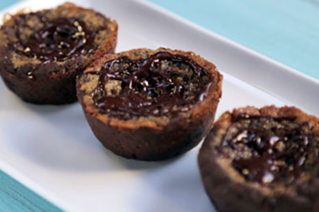 Three chocolate butter tarts seen in a close up view