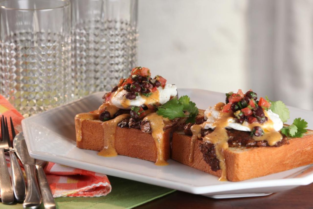 A thick-cut Toast topped with eggd benedict, black beans and fresh salsa