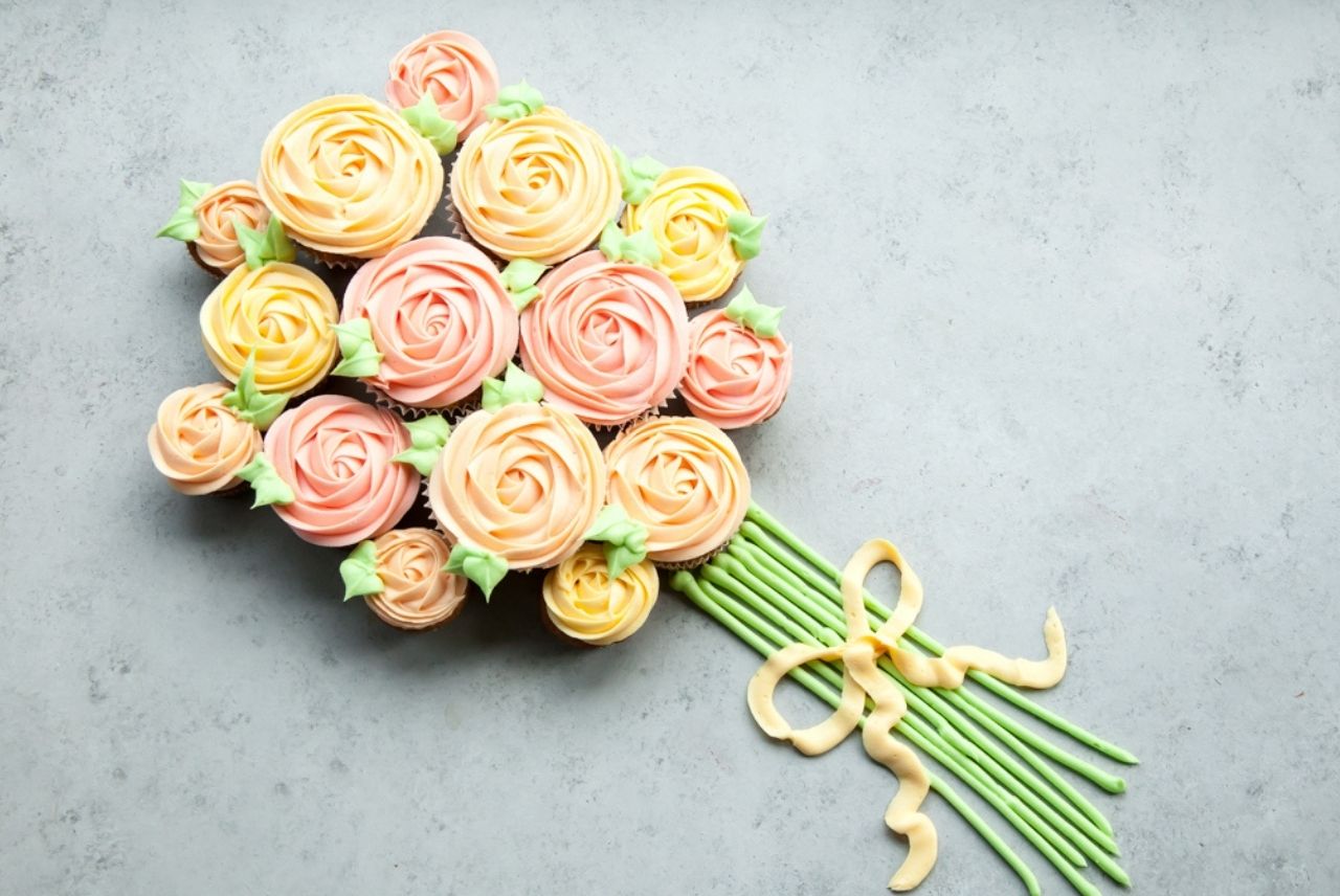 Pink and orange cupcakes arranged like a flower bouquet