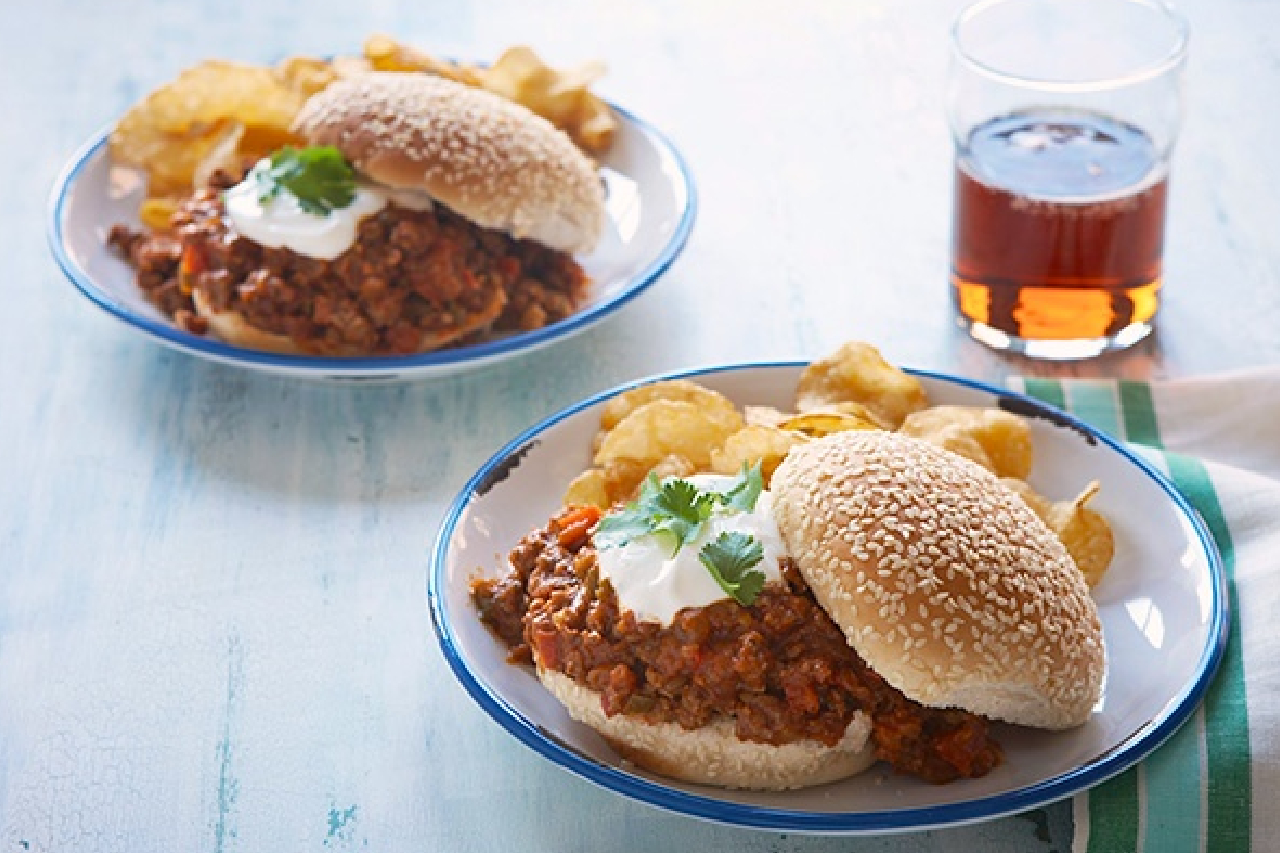 A shot of sloppy joes served with kettle chips