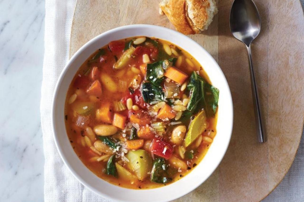 Minestrone soup with beans, collard greens, peppers and zucchini
