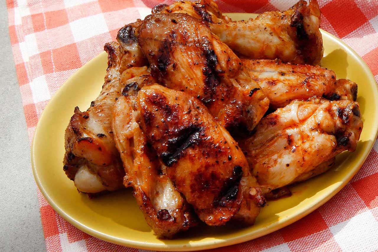 plate of grilled wings on a yellow plate