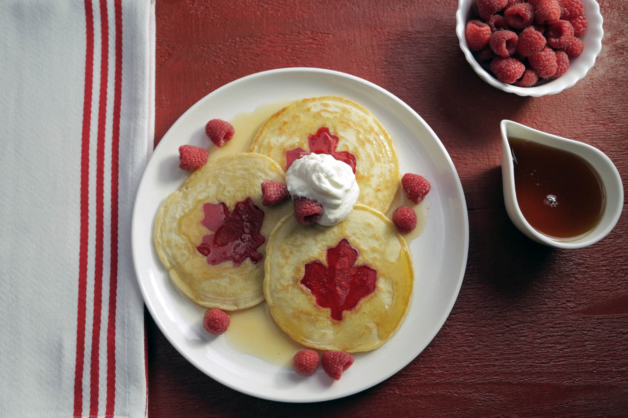 canada day pancakes with maple syrup and a dollop of whipped cream