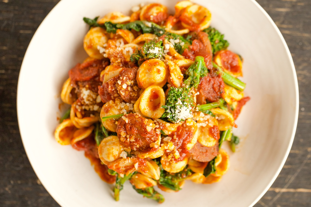 Orecchiette pasta with a red tomato sauce, broccoli rabe and crumbled sausage