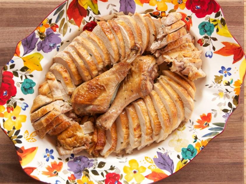 A cut-up roast turkey on a platter
