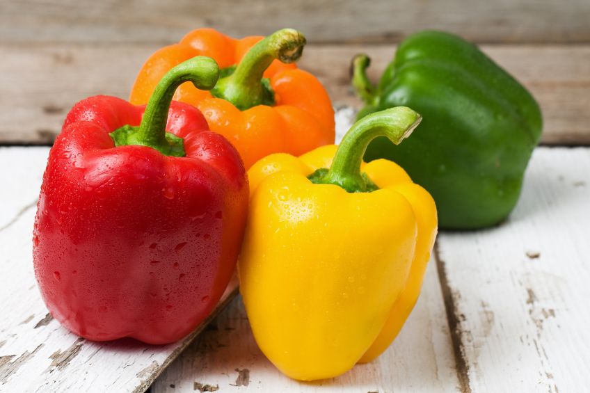 red, yellow and green peppers on a table
