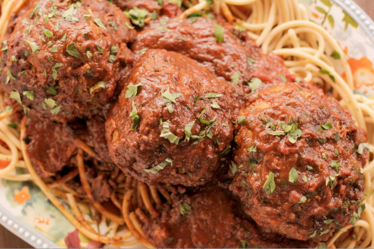 Ree Drummond's super-sized monster meatballs on a pile of spaghetti with tomato sauce
