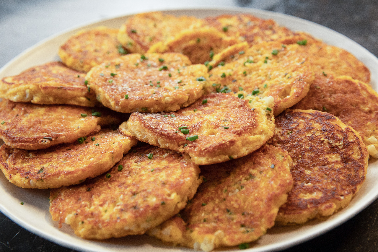 A plate with golden fried corn pancakes