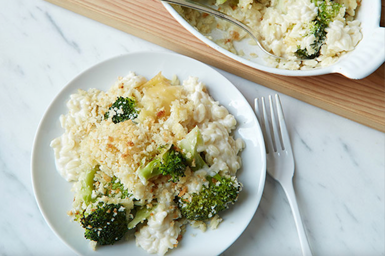 A shot of a plated portion of creamy cheese, broccoli and orzo casserole