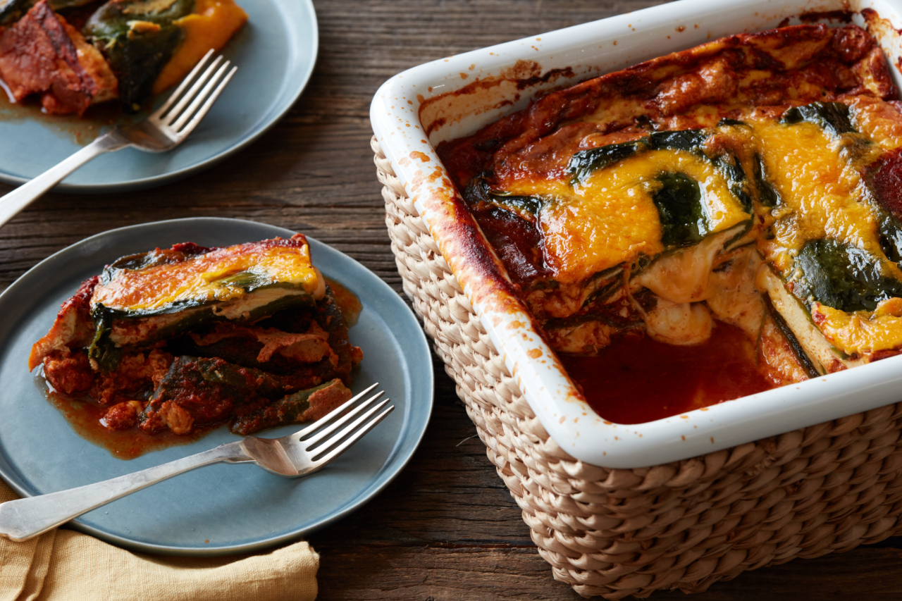 A cheesy pepper chile relleno recipe in a casserole dish with a slice taken out on a plate