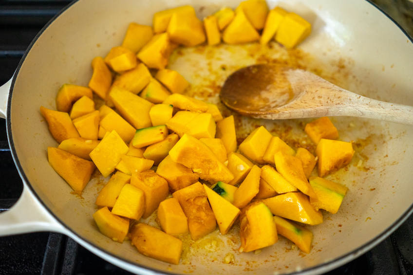 A pan with squash pieces cooking