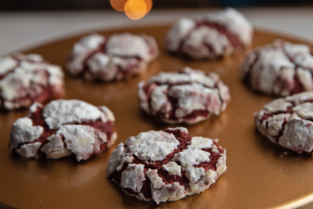 Close-up of Red Velvet Crinkle Cookies on a gold tray