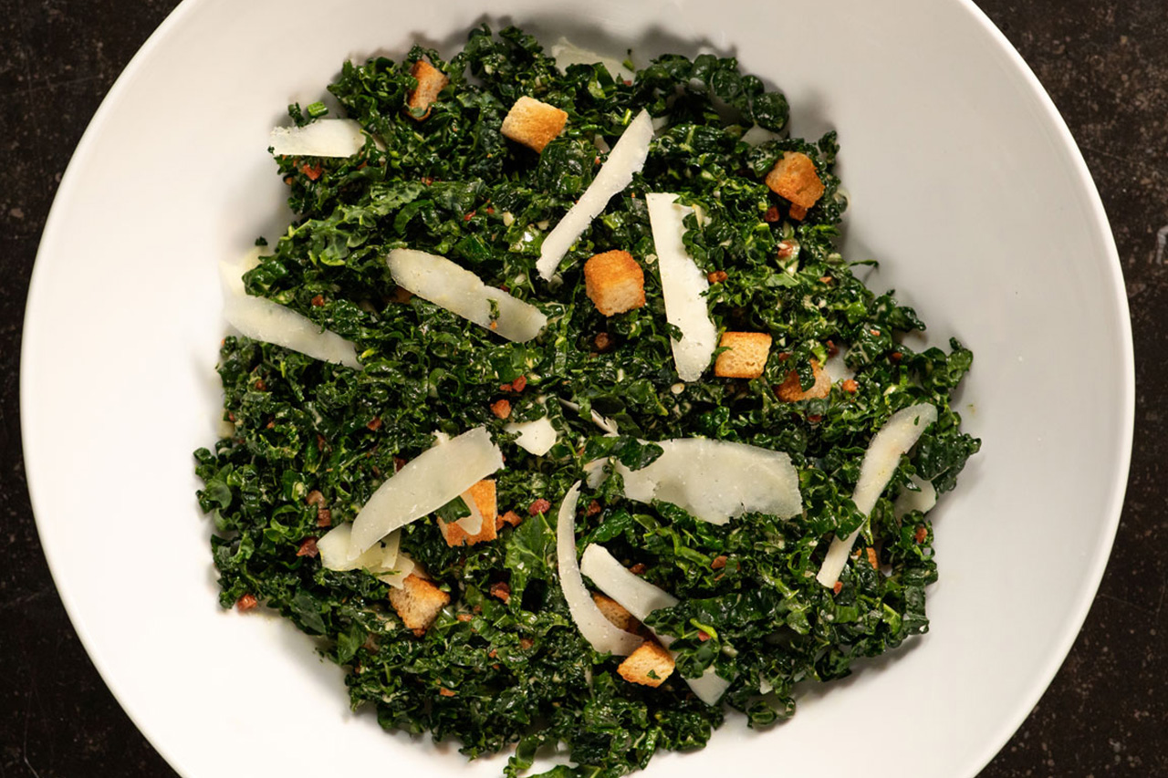 Overtop view of kale salad in a white bowl