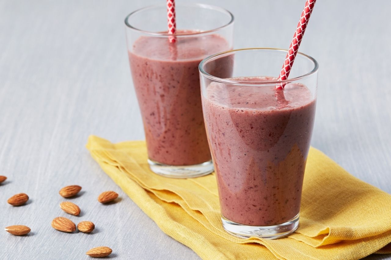 Glasses of smoothies decorated with almonds on the side