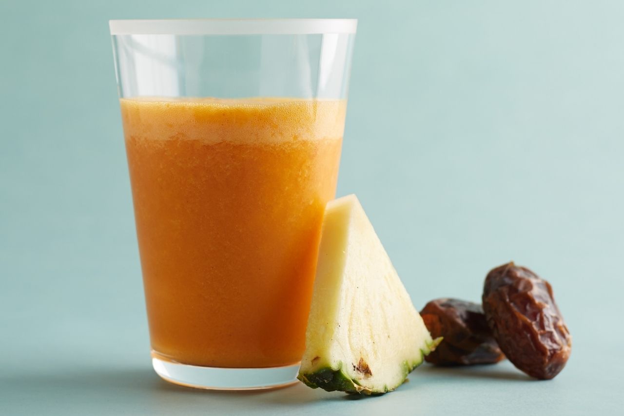 A glass of carrot and pineapple juice