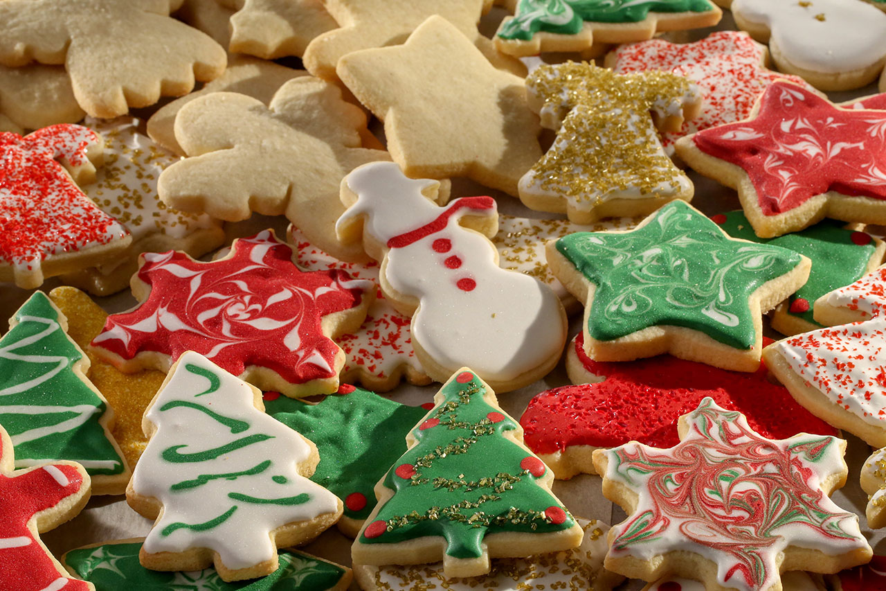 Colourful Christmas cookies in all sorts of holiday shapes on a plate