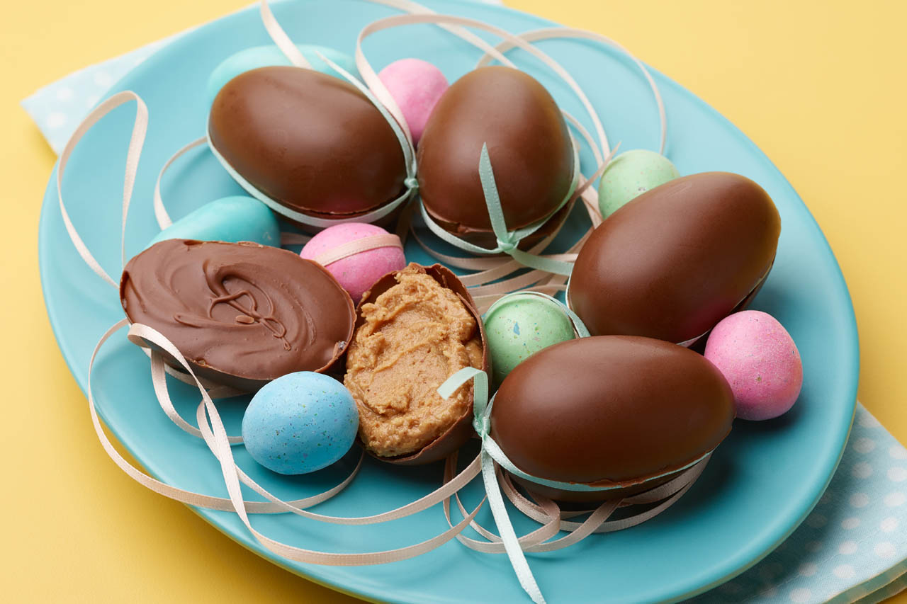 peanut butter and chocolate eggs on a blue plate