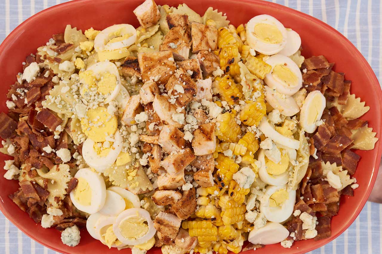 Overtop view of cobb salad on a large orange plate