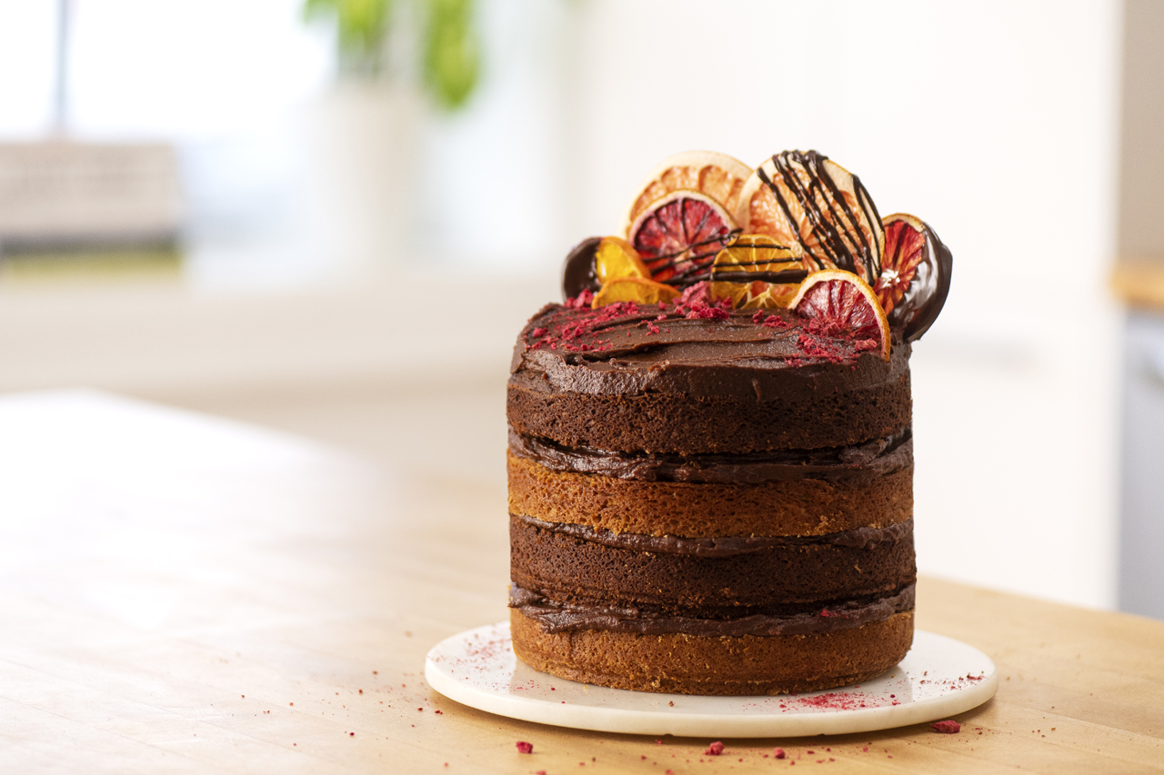 Beautiful vegan chocolate birthday cake topped with dried blood orange slices