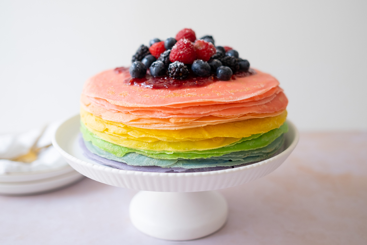 rainbow crepes on a cake stand