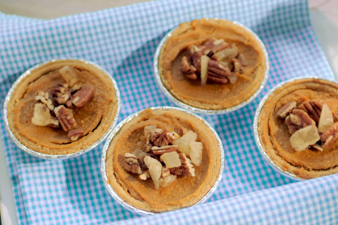 Four mini sweet potato pies with a pineapple and pecan topping