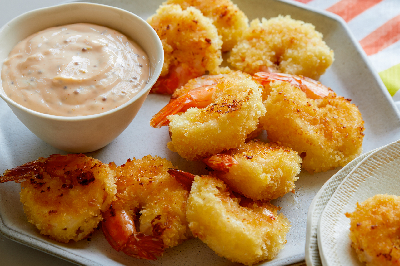Air fryer fried shrimp on a plate with remoulade sauce on the side