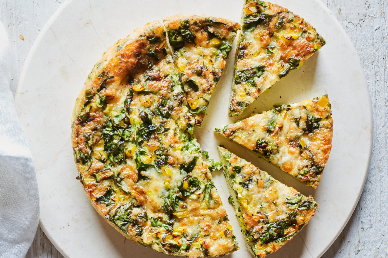 Spinach, pepper and Havarti frittata made in an air fryer, served on a white plate