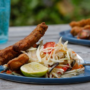 Fried Pork Belly Pairs Perfectly With Crunchy Papaya Salad in This Traditional Thai Dish