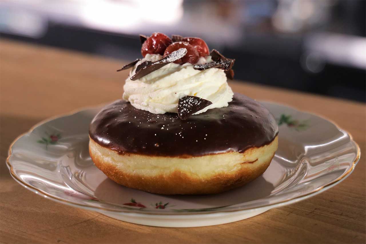 Doughnut with chocolate glaze and whip creme on top