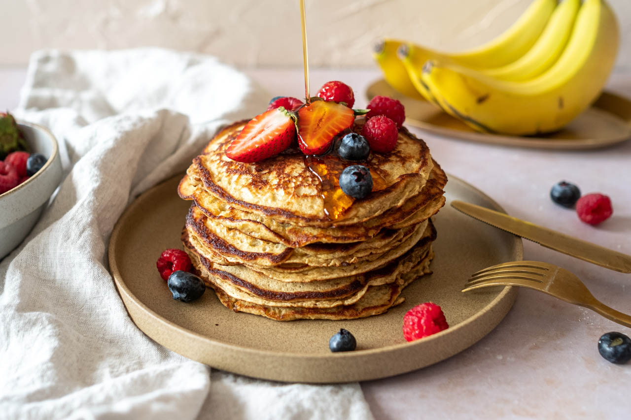 A stack of chickpea flour pancakes topped with berries
