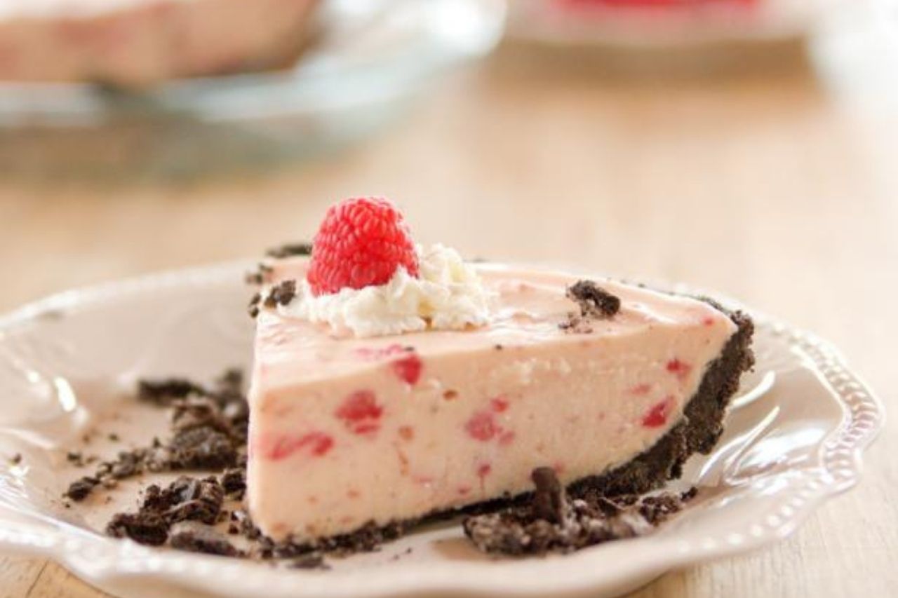 A piece of raspberry cream pie on a plate
