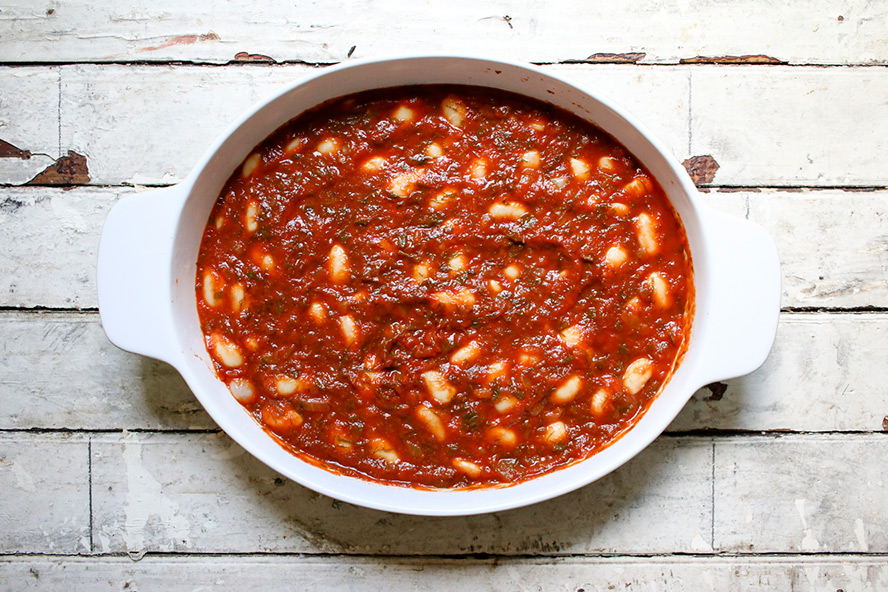 Greek beans and tomato sauce in a casserole dish