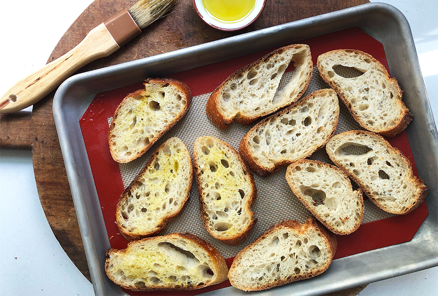 sliced baguette on a baking tray