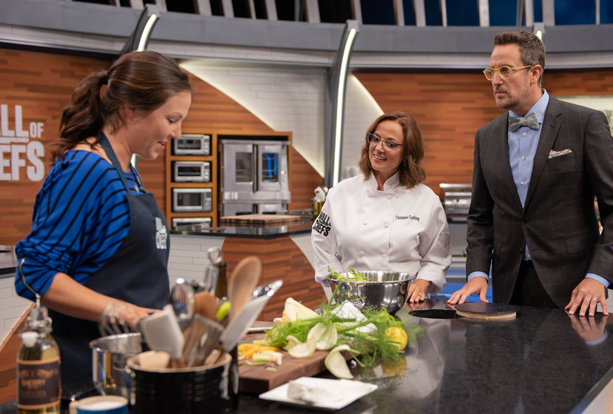 Christine Cushing and Noah Cappe check in with a home cook on the set of Wall of Chefs