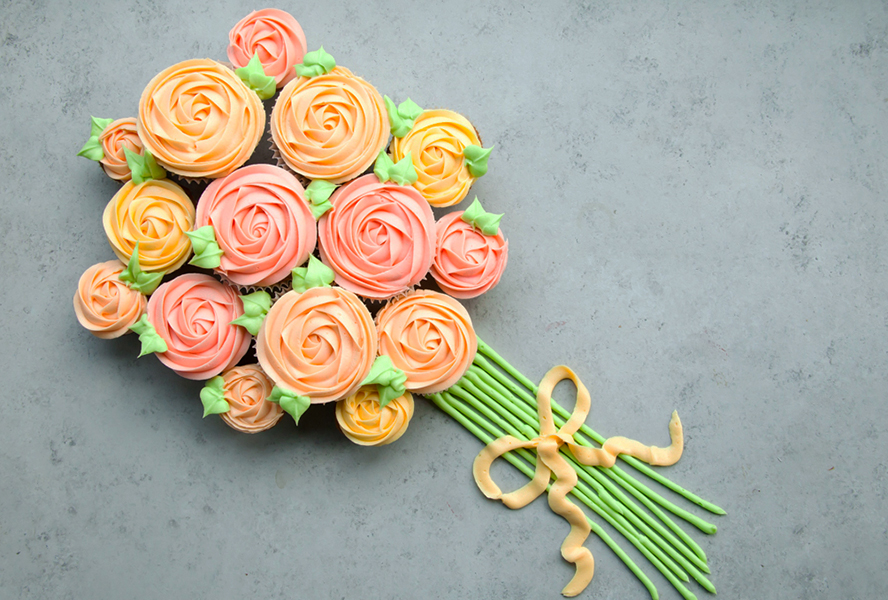 Carrot Easter cupcakes with icing on a countertop