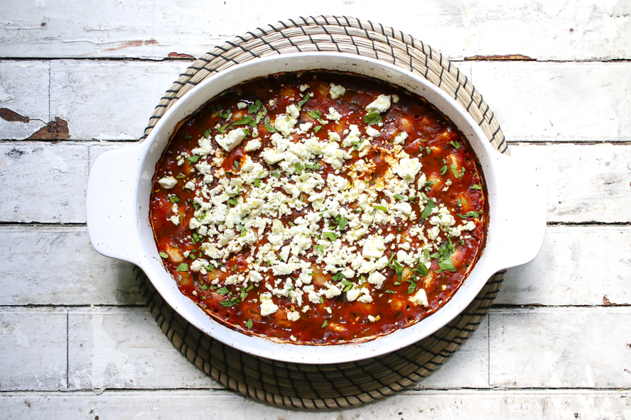 Greek-Style Baked Beans With Tomato Sauce and Feta in a white serving dish
