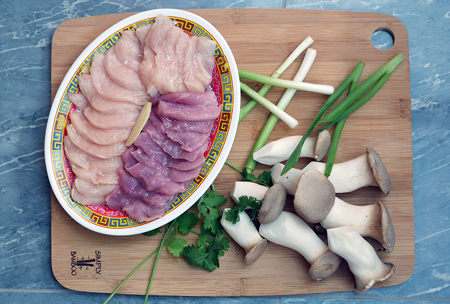 Congee ingredients including chicken, pork, mushrooms and green onion