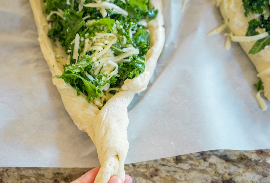 Twisting the ends of dough for khachapuri